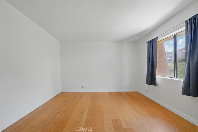 2101 E 21st St Unit 310, Signal Hill, CA 90755 - spare room with light wood-style flooring and baseboards
