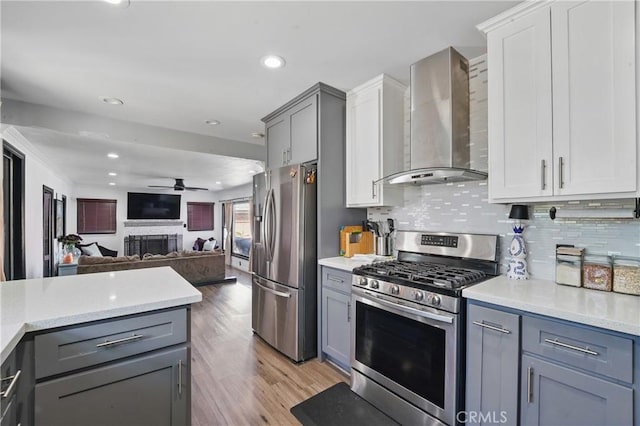 9489 Muroc St, Bellflower, CA 90706 - kitchen featuring stainless steel appliances, wall chimney exhaust hood, ceiling fan, gray cabinetry, and recessed lighting