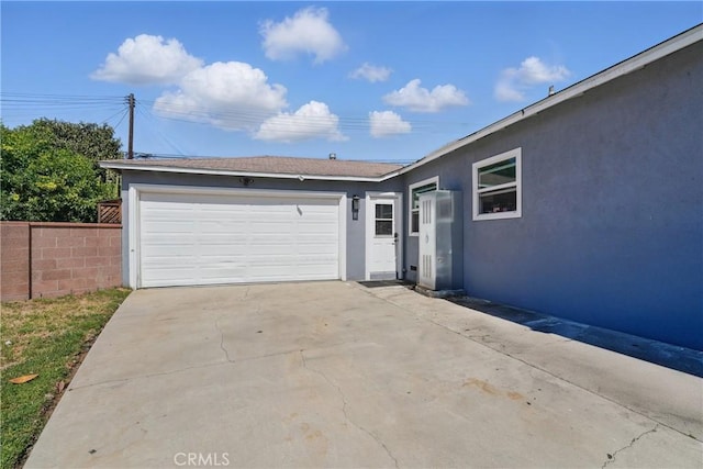 9489 Muroc St, Bellflower, CA 90706 - view of front of property with stucco siding, a garage, and driveway