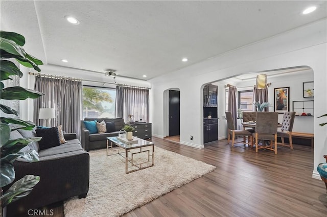 9489 Muroc St, Bellflower, CA 90706 - living area with arched walkways, wood finished floors, recessed lighting, and baseboards
