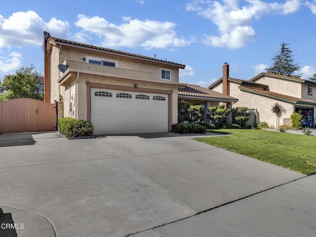 view of front facade with driveway, a front lawn, stucco siding, a gate, and a garage