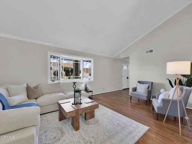 living room featuring vaulted ceiling, ornamental molding, wood finished floors, and baseboards