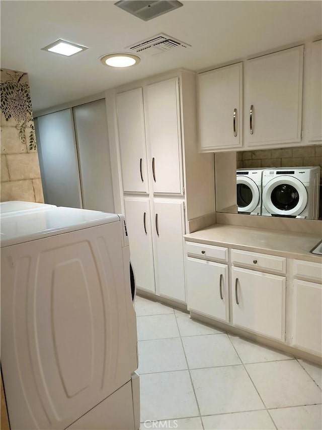 6 Whittier Ct, Rancho Mirage, CA 92270 - laundry area with cabinet space, washing machine and dryer, and light tile patterned floors