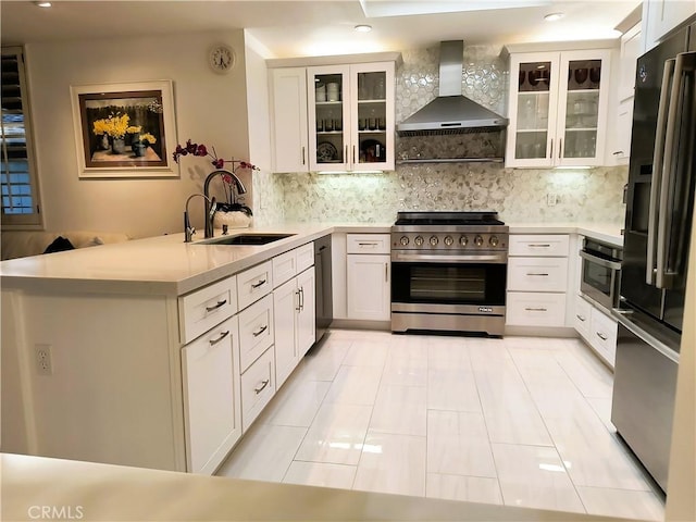 6 Whittier Ct, Rancho Mirage, CA 92270 - kitchen featuring wall chimney exhaust hood, stainless steel appliances, a sink, a peninsula, and recessed lighting