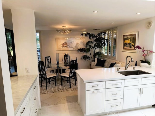 6 Whittier Ct, Rancho Mirage, CA 92270 - kitchen with a sink, a peninsula, light countertops, recessed lighting, and white cabinetry
