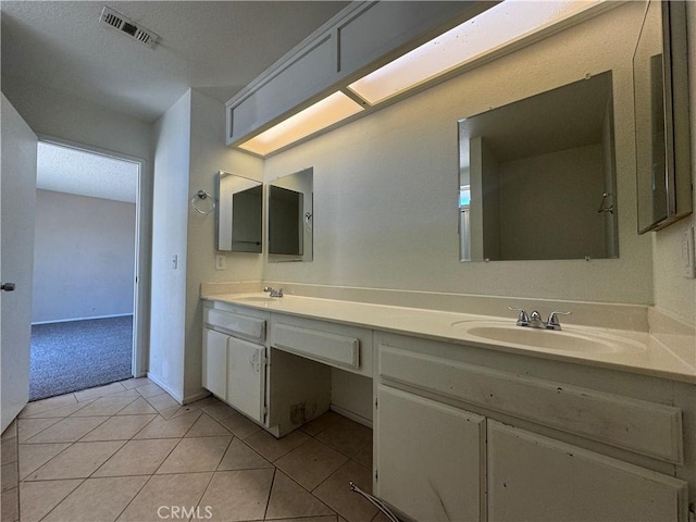 bathroom with double vanity and tile patterned floors