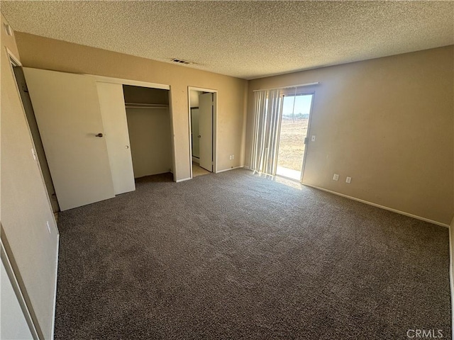 unfurnished bedroom featuring carpet flooring, a textured ceiling, and access to outside