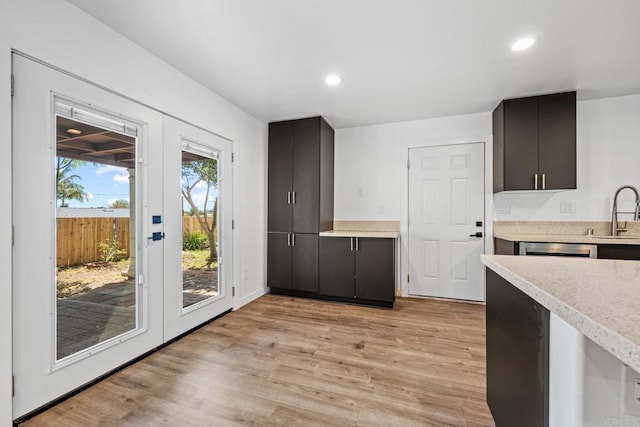 4585 Mount Henry Pl, San Diego, CA 92117 - kitchen with a sink, light countertops, light wood finished floors, and recessed lighting