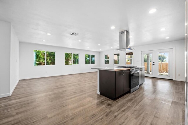 4585 Mount Henry Pl, San Diego, CA 92117 - kitchen featuring island range hood, stainless steel range with gas cooktop, french doors, a kitchen island, and light countertops