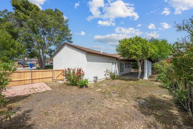 4585 Mount Henry Pl, San Diego, CA 92117 - view of home's exterior featuring stucco siding, fence, and a gate