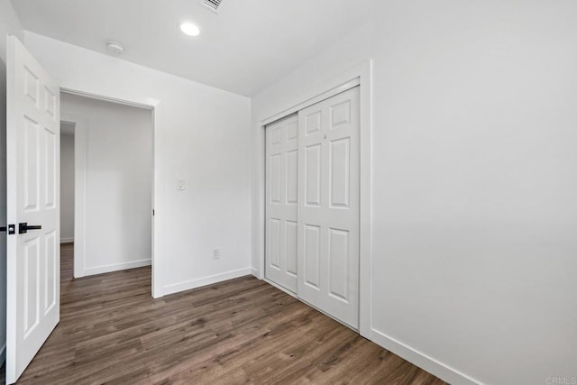 4585 Mount Henry Pl, San Diego, CA 92117 - unfurnished bedroom with baseboards, dark wood-type flooring, a closet, and recessed lighting