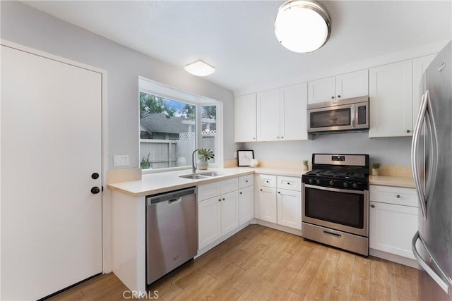 22986 Caminito Regalo Unit 92, Laguna Hills, CA 92653 - kitchen featuring stainless steel appliances, a sink, light wood-style floors, and light countertops