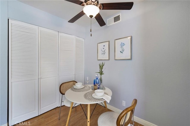 22986 Caminito Regalo Unit 92, Laguna Hills, CA 92653 - dining room featuring ceiling fan, wood finished floors, and baseboards