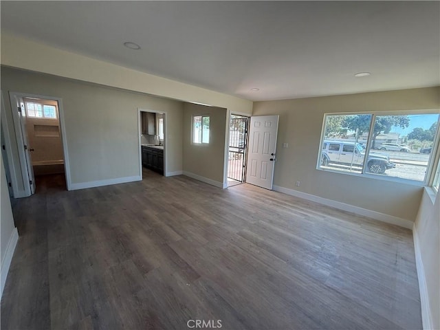 unfurnished living room with baseboards and healthy amount of natural light