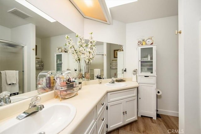 1762 Southfork Pl, Paso Robles, CA 93446 - bathroom with wood finished floors, double vanity, a shower stall, and baseboards