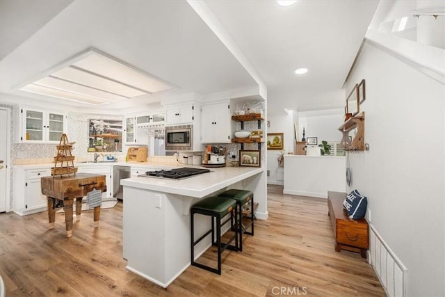 1762 Southfork Pl, Paso Robles, CA 93446 - kitchen featuring stainless steel appliances, open shelves, a peninsula, white cabinetry, and glass insert cabinets