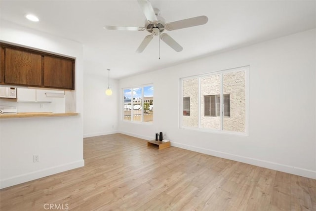 unfurnished living room featuring baseboards, light wood-type flooring, ceiling fan, and recessed lighting