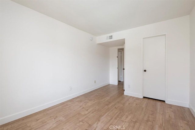 unfurnished bedroom with light wood-type flooring and baseboards
