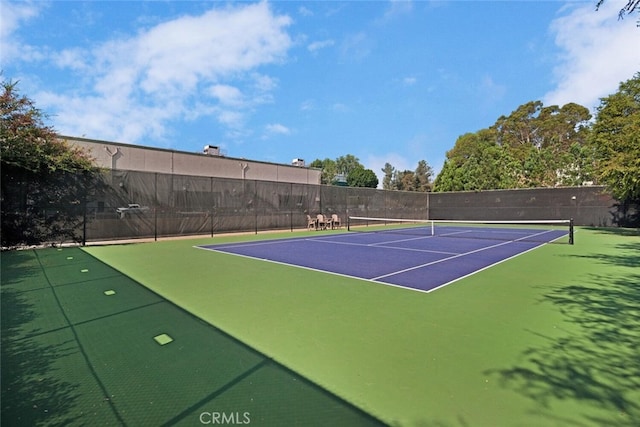 view of tennis court with fence