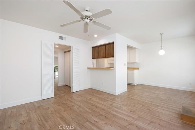 unfurnished living room with ceiling fan, light wood-style flooring, baseboards, and recessed lighting