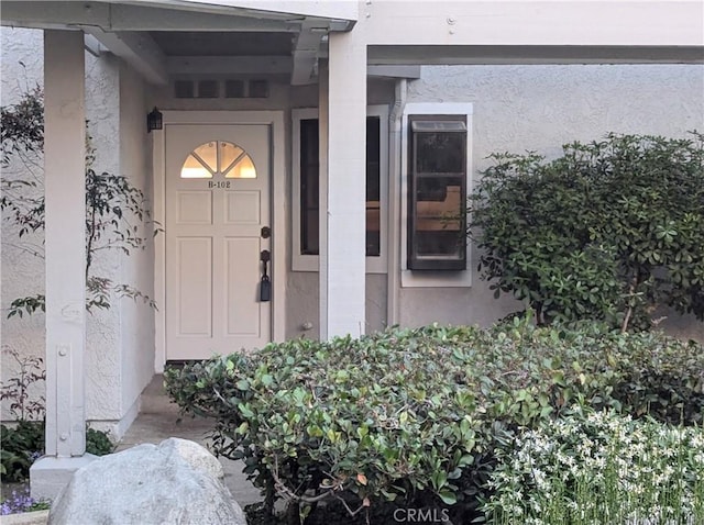 4682 Warner Ave Unit B102, Huntington Beach, CA 92649 - doorway to property with stucco siding