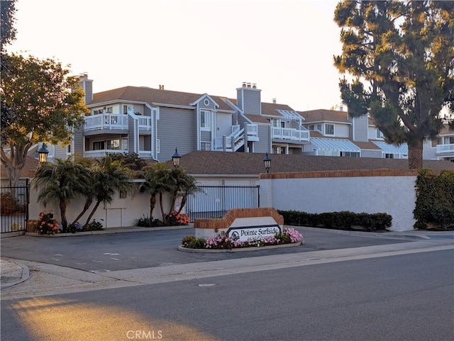 4682 Warner Ave Unit B102, Huntington Beach, CA 92649 - view of property featuring a residential view and fence