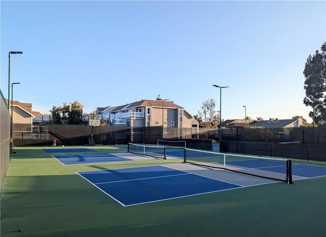 4682 Warner Ave Unit B102, Huntington Beach, CA 92649 - view of tennis court with community basketball court, fence, and a residential view