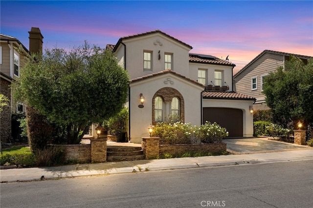 4067 Hoosier Lawn Way, Yorba Linda, CA 92886 - mediterranean / spanish-style house featuring concrete driveway, solar panels, a tiled roof, stucco siding, and a garage