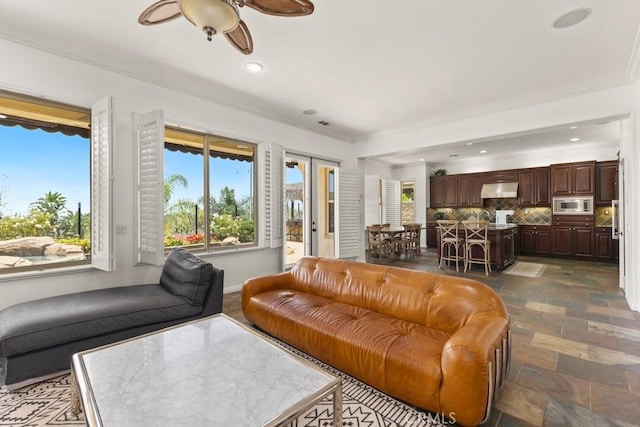 4067 Hoosier Lawn Way, Yorba Linda, CA 92886 - living area with ornamental molding, healthy amount of natural light, ceiling fan, recessed lighting, and dark stone finish floors
