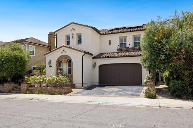 4067 Hoosier Lawn Way, Yorba Linda, CA 92886 - mediterranean / spanish-style house featuring an attached garage, a tile roof, solar panels, stucco siding, and driveway