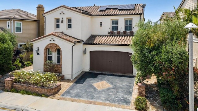 4067 Hoosier Lawn Way, Yorba Linda, CA 92886 - mediterranean / spanish-style house with a tile roof, stucco siding, asphalt driveway, and roof mounted solar panels