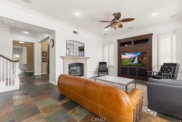 4067 Hoosier Lawn Way, Yorba Linda, CA 92886 - living room featuring stone tile floors, a ceiling fan, baseboards, a glass covered fireplace, and stairs