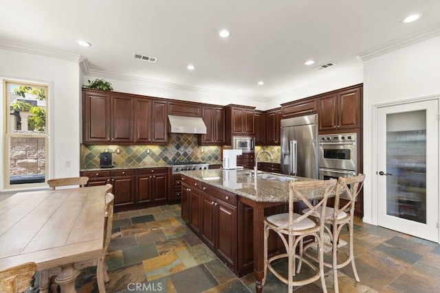 4067 Hoosier Lawn Way, Yorba Linda, CA 92886 - kitchen featuring built in appliances, a sink, ventilation hood, a kitchen breakfast bar, and decorative backsplash