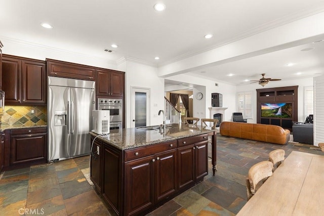 4067 Hoosier Lawn Way, Yorba Linda, CA 92886 - kitchen with stainless steel appliances, a sink, a kitchen breakfast bar, a fireplace, and stone tile flooring