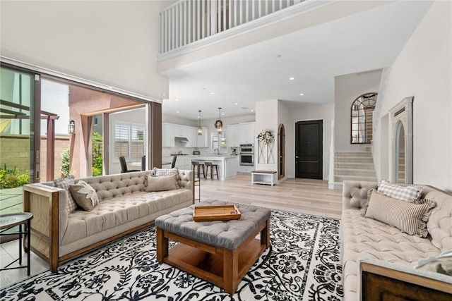 143 Trumpet Flower, Irvine, CA 92618 - living room featuring stairway and light wood-style flooring