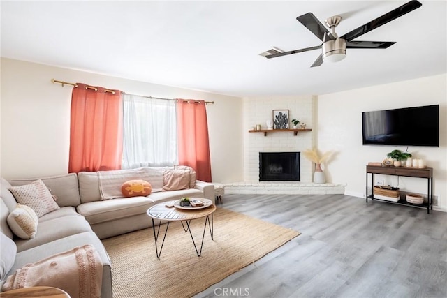 57966 El Dorado Dr, Yucca Valley, CA 92284 - living room with ceiling fan, wood finished floors, and a fireplace
