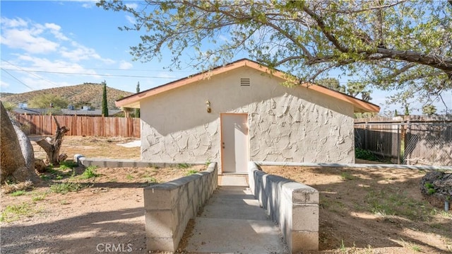 57966 El Dorado Dr, Yucca Valley, CA 92284 - view of side of property with fence and stucco siding