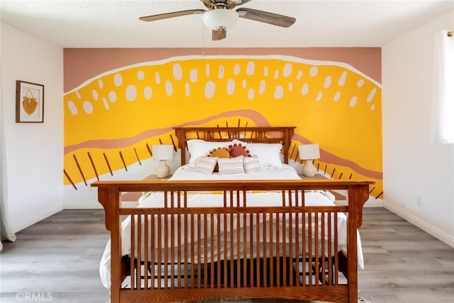 57966 El Dorado Dr, Yucca Valley, CA 92284 - bedroom featuring baseboards, wood finished floors, and a ceiling fan
