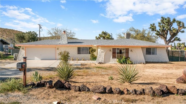 57966 El Dorado Dr, Yucca Valley, CA 92284 - single story home with concrete driveway, an attached garage, a chimney, and stucco siding