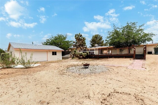 57966 El Dorado Dr, Yucca Valley, CA 92284 - view of yard with a wooden deck, an outdoor fire pit, and fence