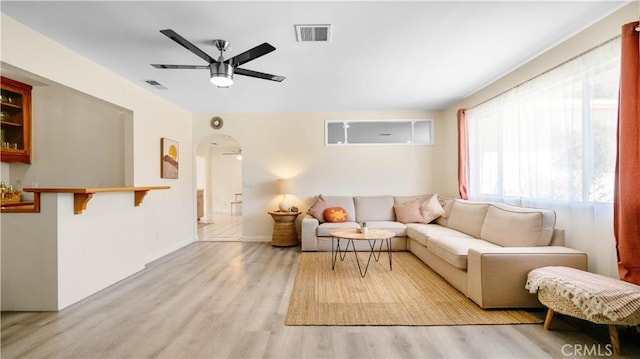 57966 El Dorado Dr, Yucca Valley, CA 92284 - living area featuring a ceiling fan, light wood-style flooring, arched walkways, and baseboards