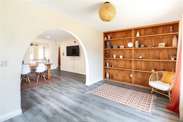 57966 El Dorado Dr, Yucca Valley, CA 92284 - living area featuring arched walkways, wood finished floors, and baseboards