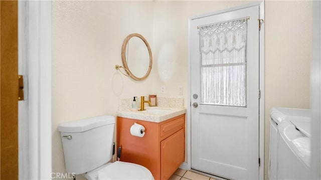 57966 El Dorado Dr, Yucca Valley, CA 92284 - bathroom with washer and dryer, vanity, toilet, and tile patterned flooring