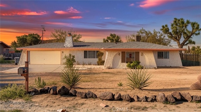 57966 El Dorado Dr, Yucca Valley, CA 92284 - ranch-style home featuring driveway, a garage, a chimney, and stucco siding