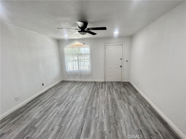 128 E 1st St, Buttonwillow, CA 93206 - empty room featuring wood finished floors, ceiling fan, baseboards, and a textured ceiling