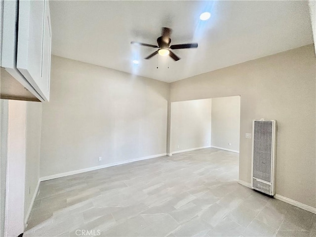 128 E 1st St, Buttonwillow, CA 93206 - empty room featuring a heating unit, ceiling fan, and baseboards