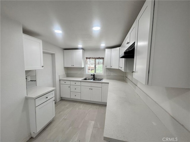 128 E 1st St, Buttonwillow, CA 93206 - kitchen with a sink, recessed lighting, under cabinet range hood, and white cabinetry