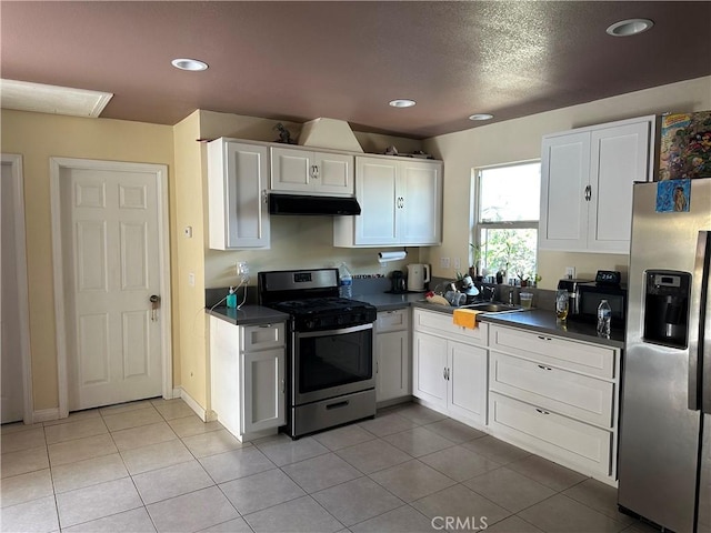 23610 David Ln Unit 1, Moreno Valley, CA 92557 - kitchen with stainless steel appliances, under cabinet range hood, dark countertops, white cabinetry, and recessed lighting