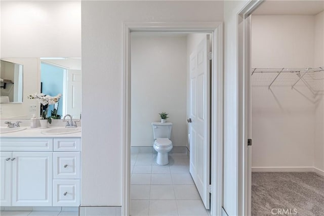 41207 Alegria Ln, Lake Elsinore, CA 92532 - bathroom with a spacious closet, toilet, double vanity, tile patterned floors, and baseboards