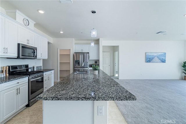 41207 Alegria Ln, Lake Elsinore, CA 92532 - kitchen featuring stainless steel appliances, a sink, white cabinets, dark stone counters, and recessed lighting
